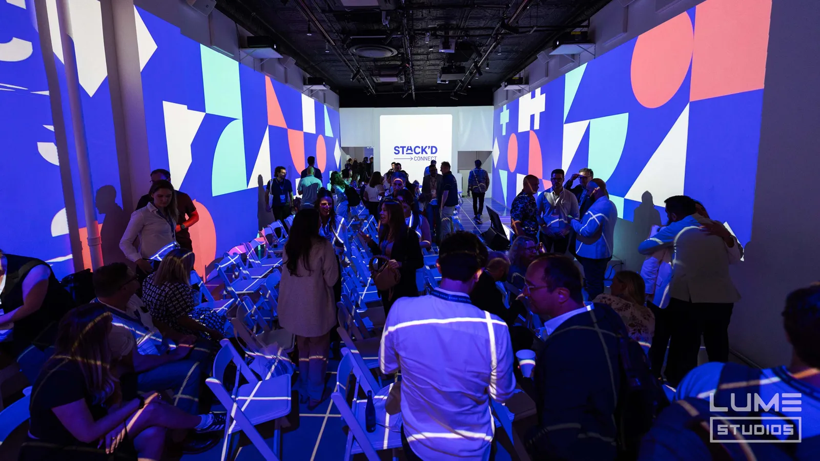 Guests at a brand event inside a projected room